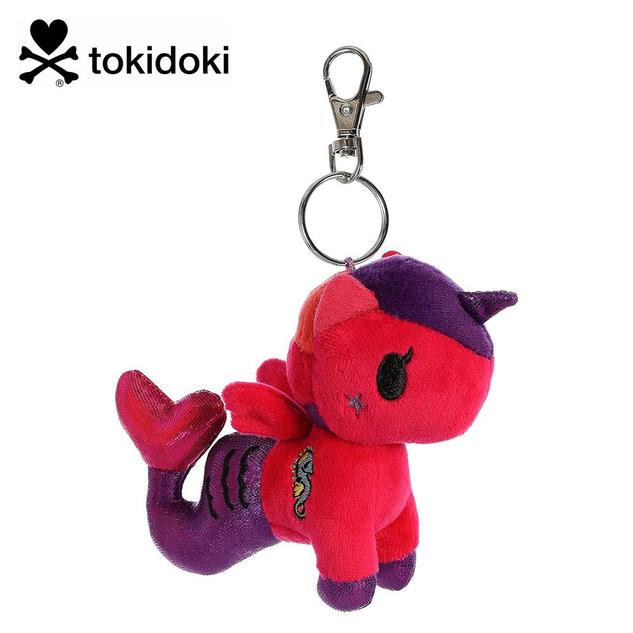 A keychain featuring a plush mermicorn in red and purple, with a seahorse design on the side.