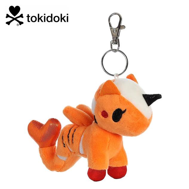 A keychain featuring a plush mermicorn in orange, with a black horn, and a tiger stripe design on the side.