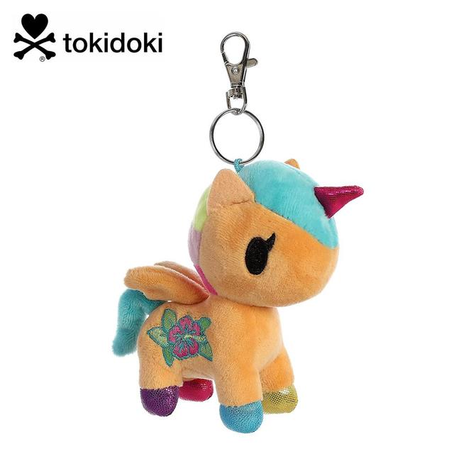 A keychain featuring a plush winged unicorn in light orange, with a multicoloured mane and tail, and a flower design on the side.
