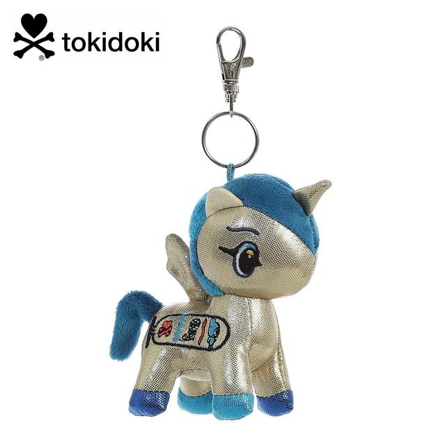 A keychain featuring a plush winged unicorn in metallic gold, with a blue mane and tail, and a logo design on the side.