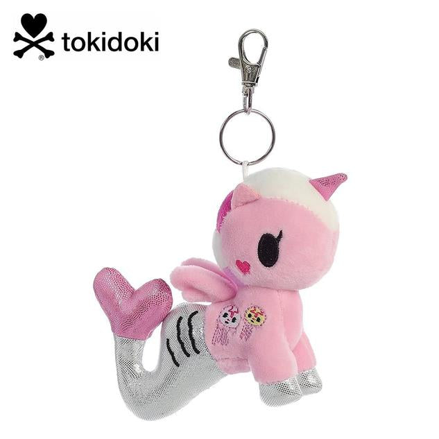 A keychain featuring a plush mermicorn in light pink, with a silver tail, and a jellyfish design on the side.