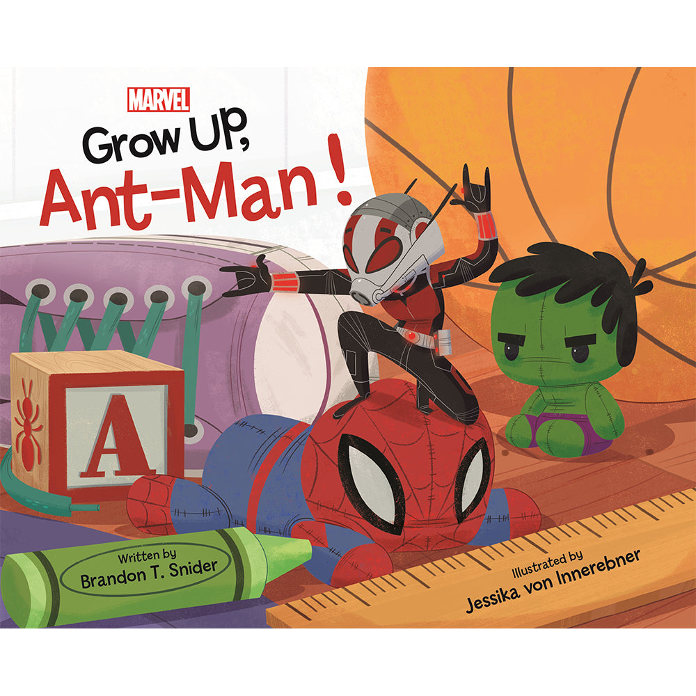Ant-Man poses on top of a plushie Spider-Man. Around him, a plushie Hulk, basketball, crayon, ruler, building block and shoe make it apparent he is approximately the size of a hand.