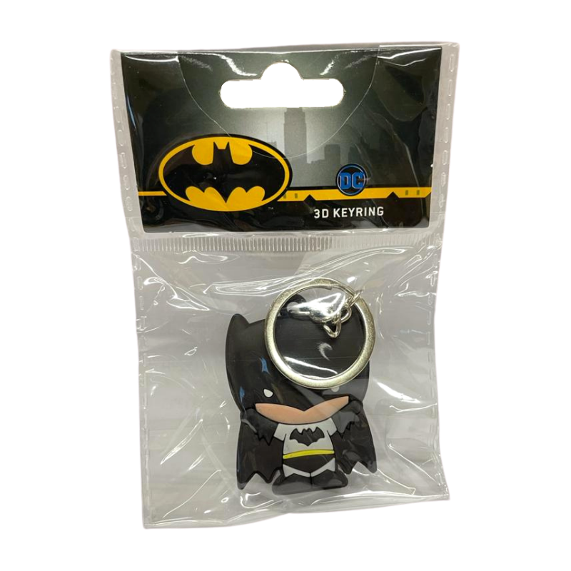 A keychain of a cartoon man with light skin in a chibi style. He is wearing a black helmet that covers the upper half of his head and has batlike ears. He is wearing a grey suit with a black bat symbol, black pants, boots and gloves, and a yellow belt, as well as a dark cape that looks like bat wings.