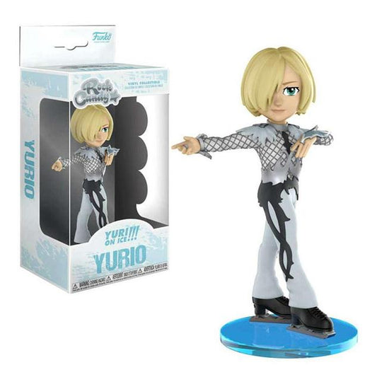 A figurine of Yurio, a person with chinlength blond hair, in his silver agape skating costume, one arm outstretched and the other close to his chest. He stands on a blue circular disc, and is featured in a Rock Candy box with a display window.