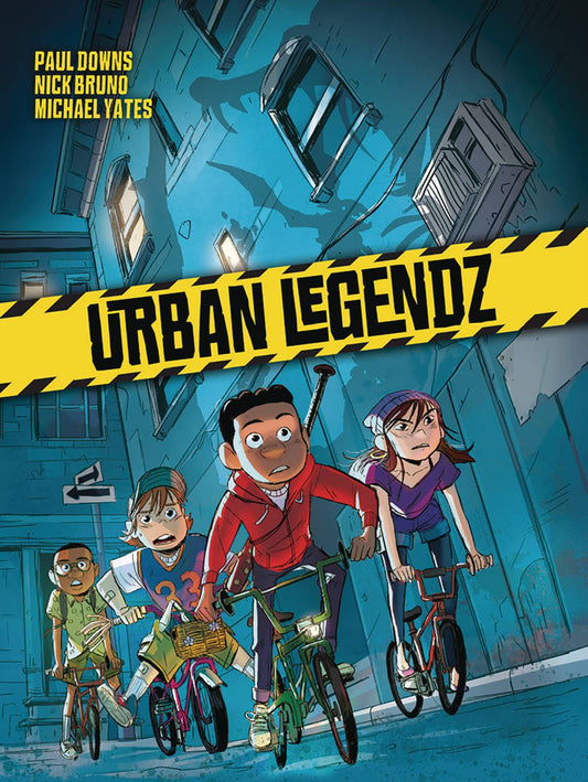 Four kids on bikes - two Black boys, a white boy and a white girl - ride through a back street after dark. The shadows form monsters against the walls of a nearby building. 
