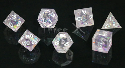 A set of clear polydice with sharp edges and white numbering. Inside are pink holographic flakes that refract the light.