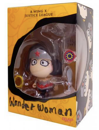 A chibi-style figurine of Wonder Woman featuring large stylised eyes and several accessories. It is encased in an orange window box.
