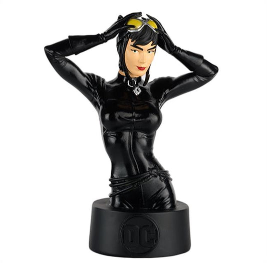 A bust statue of Catwoman, her hands held up to adjust the goggles atop her head.